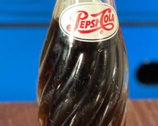 1950s Pepsi 6.5 Oz Swirl Bottle Full	8in H x 2.25in diameter at bottom	

