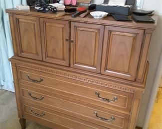 Tall Men's Dress with Several Drawers and Opens up. 3 Drawers below and Cabinet inside for accessories and socks and things. On top Men's collectibles, like wallets and variety items.