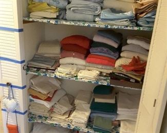 Sheets and Bedding, Pillow Cases. Women's Knitted Sweaters, thick and thin, nylon, cotton, polyester, rayon, heavy wool. Embroidered tea towels, regular tea towels, regular towels and variety large bedding pieces. 2 small travel purses.