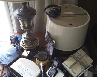 Close up Bronze Lamp, Variety Clocks. Westinghouse Mistaire Women's Hair Dryer (large round item).