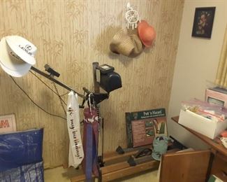 Vintage Nordic Track Exercise Equipment with Manuals. Straw Hats, Sun Hats. Golf Putting Practice Game. Blue Exercise Mat. Pictures.