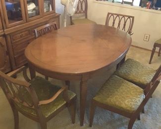 View of Oval Oak Dining Table. This has 8 chairs and 1 odd chair. This has 2 Leaves.