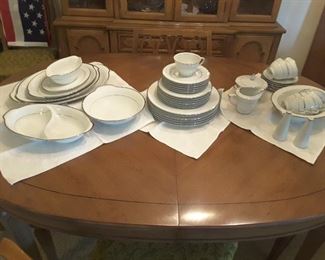 Oval Oak Dining Table (has 2 leaves). Style House Wedding Band Dish Set, 42 pieces. Dinner, Salad, Bread, Butter, Cups, Saucers, Round Vegetable, Gravy, Oval Vegetable, Sugar and Creamer, Oval Platters.