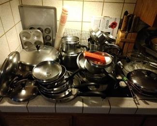 Kitchen: 24 Piece Faberware 12 pots, 12 lids, Muffin Baking Tins, Cupcake Pans, Cookie Sheet, Baking Rack, Collection of Knives, Knife Block. SS French Garnishing Cutter, Boxed Bread Knives. Kitchen Stolz 6 piece Knives and Sharpener.