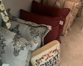 Pillows including a needlepoint pillow