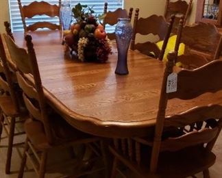 Oak dining table, 1 arm chair, 8 side chairs, china hutch to match.