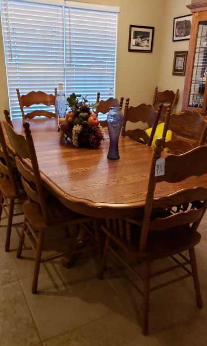 Oak dining table, 1 arm chair, 8 side chairs, china hutch to match.