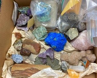 Box of raw geodes, fossils, minerals, crystals.