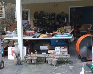 Tons of goodies under carport
( orange fan not for sale)