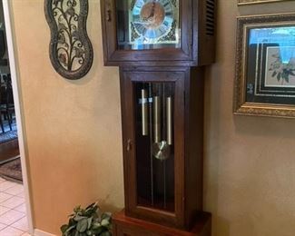 This grandfather clock was custom made in Japan of teak and burl wood to match the entertainment center.  