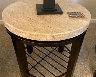 # 3 $290  24" diameter x 24"h.  Stone top on an iron base with a lower shelf. 