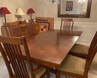 #7 $900. Green River Wood Co, dining set.  Table is 42"w x 84" x 30"h as shown with a leaf in place that is 18" wide.  Two captain chairs and four side chairs.  Beautiful mission style with plank top,