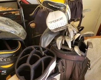 Assorted golf bags and clubs