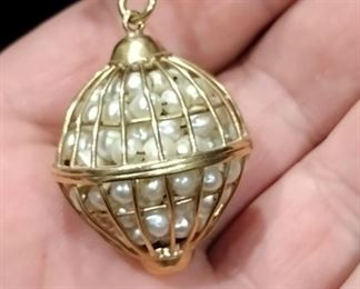 gold necklace with huge pendant slam full of pearls 