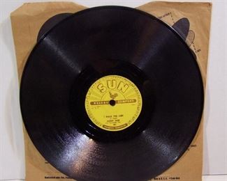 2510   2 pc. Johnny Cash collector lot includes:  Original Johnny Cash 78 record “I Walk the Line/Get Rhythm”, Sun Record Company, 10” dia. and a dated 1966 Johnny Cash Show souvenir picture and song booklet, 32 pages, Black and white with color cover, 9” x 12” h. softbound. Cond: Record shows light wear from play, Program has some light creases & light wear to the corners.