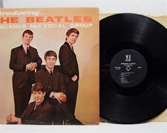 2543   Vee-Jay VJLP 1062, July 22, 1963, “Introducing the Beatles” Cond: Record shows play with some minor wear around the center hole. Cover spine has minor corner wear, back upper corner lightly inscribed with a name & phone # with small paper loss, Front shows slight wear & 2 light creases at RH edge. Overall: 7.5 Rating.