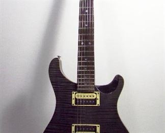 2554   Paul Reed Smith (PRS) SE Custom Electric Guitar. Solid body, Steel/Grey Flame Top, Rosewood Finger Board, Humbucker Pickups, Serial # F13198. Includes orig. padded Gig bag.   Cond: Minor wear & pick scratches from use.