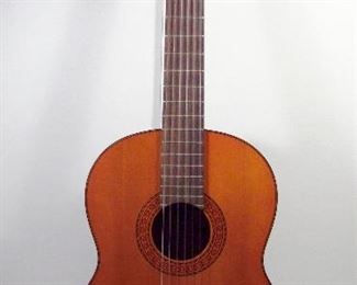 2555   Vintage Yamaha Classical Acoustic Guitar. Model G-65A, Rosewood finger board, Nylon strings, includes a “Guild” Hard Shell case.  Cond: Very minor wear from light use.