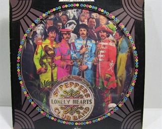 2565   Capitol SEAX 11840 (LP), 1978 Limited Edition Picture Record with Window sleeve/cover. “Sgt. Pepper’s Lonely Hearts Club Band”, Cond: Record appears un-played, Cover spine shows wear including all 4 corners, small hard crease in upper right corner of cover. Overall: 7.5 Rating.