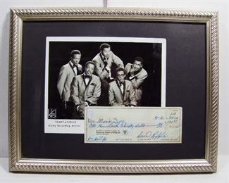 2575   1979 Autographed David Ruffin Bank Check. Former Lead singer for the Temptations, Died 1991, Framed with a period Temptations group photo in a silver frame 18” X 14”h. Cond: The photo has some creases in the lower left area.
