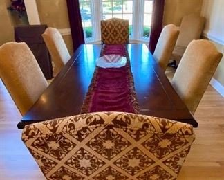 The Dining Room Table and 8 Chairs.  The Dining Room Table was Custom Made from Honquest Furniture in Barrington, IL.  2 Captain Chairs and 6 Dining chairs with Leather Seats.    The Table is absolutely Beautiful with double pedestal legs.