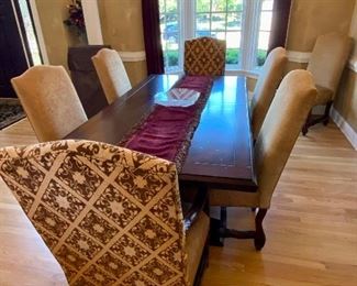 The Dining Room Table and 8 Chairs.  The Dining Room Table was Custom Made from Honquest Furniture in Barrington, IL.  2 Captain Chairs and 6 Dining chairs with Leather Seats.    The Table is absolutely Beautiful with double pedestal legs.