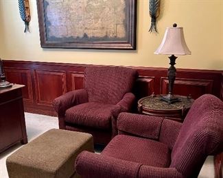 Two upholstered chairs and ottoman.  In the background you’ll see an old world map repro, flanked by two interesting sconces!  