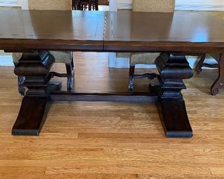 The Dining Room Table and 8 Chairs.  The Dining Room Table was Custom Made from Honquest Furniture in Barrington, IL.  2 Captain Chairs and 6 Dining chairs with Leather Seats.    The Table is absolutely Beautiful with double pedestal legs.