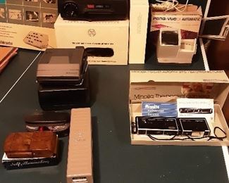 Several vintage cameras, Kodak 650 slide projector with carousel slide tray and stack loader and other slide viewers