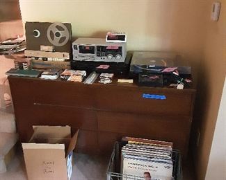 Vintage Bell reel to reel tape transport.  Various 1980's stereo equipment.  LP records.  And a 6 drawer Mid Century Modern dresser