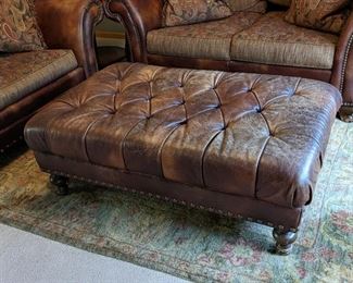 King Hickory Leather Ottoman. There is no maker tag, but matches the next few lots. There is some wear/ scratches that can be seen in the photos. Measures 30” x 48” and 18” high. 