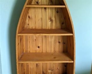 Ducks Unlimited Canoe Bookshelf. The very top is chipped which can be seen in the photos. Measures 70” high, 11” deep and 27” wide at the largest portion.