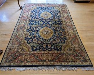 Colorful Area Rug. There is wear and damage to the fringes that can be seen in the photos. Measures 64" x 103".