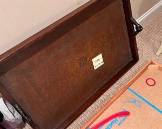 Leather topped seeming tray with bronze hands handles 