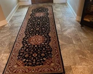 Beautiful runner matches round  rug under dining table 