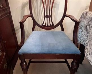 Mahogany dining room table, 5 armless chairs, one Captain’s chair, pads, 2 leaves