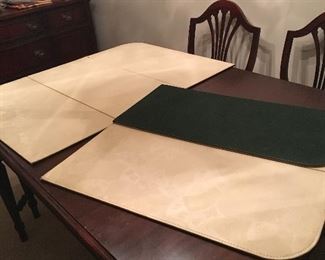 Mahogany dining room table, 5 armless chairs, one Captain’s chair, pads, 2 leaves