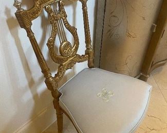 Pair of gold gilted chairs.