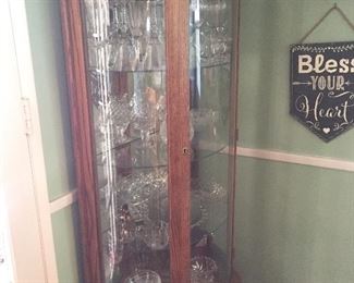 One of two beautiful, lighted curio cabinets.