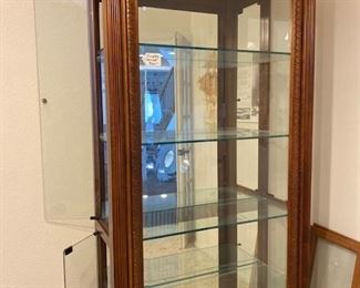 Curio cabinet is lite from the top