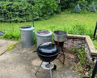 small charcoal grill; metal trash cans
