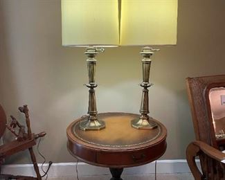 Mid 20th Century Sloan Style Leather Top Drum Table 2 Tall Brass Lamps and Framed Art