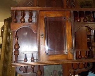 Small Antique Wooden Victorian Wall Display with Ornate Carving Beveled Glass Door in Center and Mirror for Shelf at Bottom
