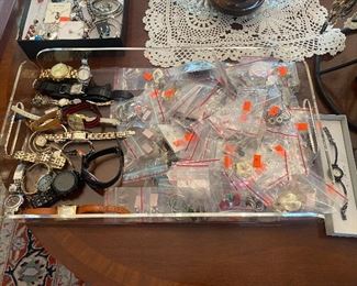 Watches and lot of pierced earrings.