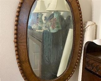 Oval wood framed mirror.