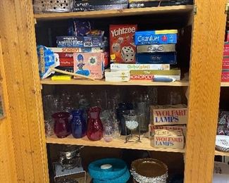 Games, vases, serving pieces, and vintage Wolfard oil lamps.