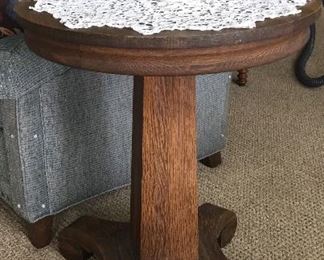 Oak pedestal side table works well as an end table. Or, add two chairs to make it a fun dining spot. 