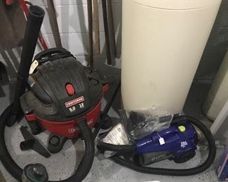 A Craftsman vac and Dirt Devil sweeper, each with accessories. 