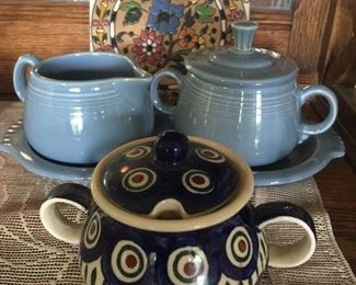 Shades of blue star in these colorful pieces. Feature are a decorative tile, Fiesta cream and sugar on tray and hand-crafted pot ideal for sugar, jam or honey. 