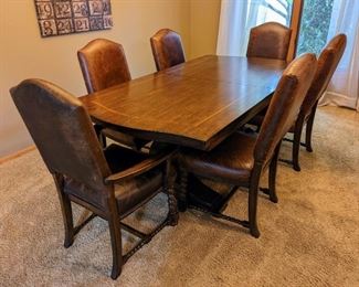 Eddie Bauer Lane Lakeridge Trestle Dining Set. A gorgeous set with leather and spindle leg chairs! There are a few light scratches on the table top, but all pieces are in otherwise great condition. The table includes two additional leaves.

The table measures 44” x 84” and 30” high and comes with two leaves each measuring 18" which allows toe table to extend to 102" or 120" for ample seating!

Each side chair measures 21” wide, 20” deep, 19” high to the seat and 43” high to the chair back.